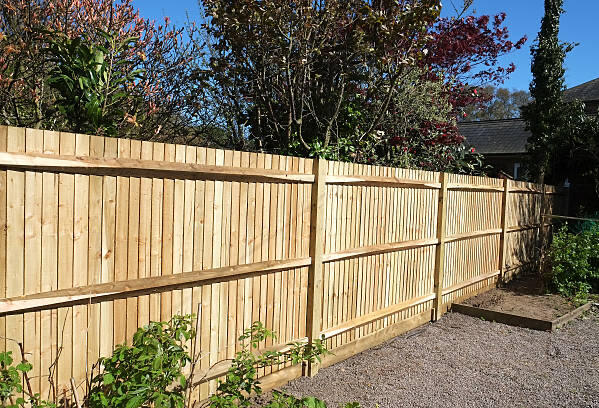 Feather edge fencing installed in Bude A beautifully installed feather edge fence with a matching wooden gate, creating a secure and stylish boundary for a landscaped garden. This example of expert craftsmanship in closeboard and picket fencing is perfect for homeowners in Bude, Rock, Padstow,